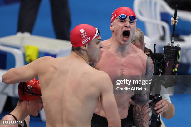 James Guy of Team Great Britain and Adam Peaty of Team Great Britain celebrate winning gold in the Mixed 4 x 100m Medley Relay Final at Tokyo...