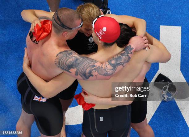 Adam Peaty, Anna Hopkin, James Guy and Kathleen Dawson of Team Great Britain celebrate winning the gold medal in the Mixed 4 x 100m Medley Relay...