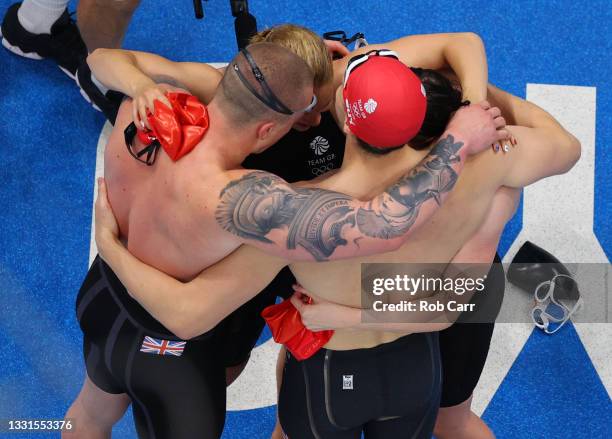 Adam Peaty, Anna Hopkin, James Guy and Kathleen Dawson of Team Great Britain celebrate winning the gold medal in the Mixed 4 x 100m Medley Relay...