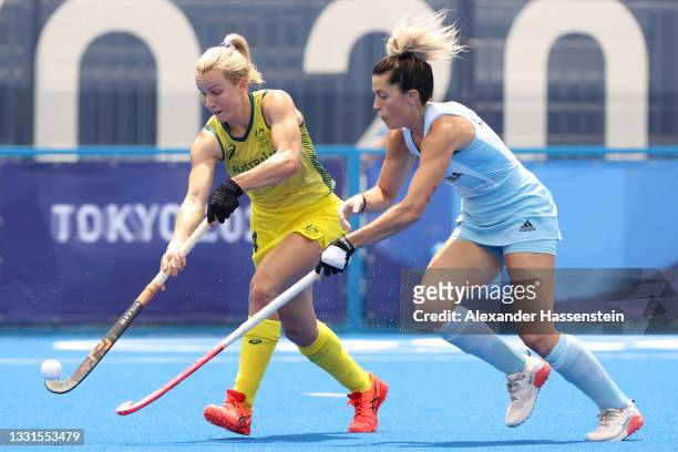 Amy Rose Lawton of Team Australia moves the ball past Agustina Albertarrio of Team Argentina during the Women's Preliminary Pool B match between...