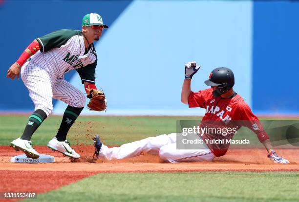Tetsuto Yamada of Team Japan steals second base as Ramiro Pena of Team Mexico covers second base in the first inning during the baseball opening...