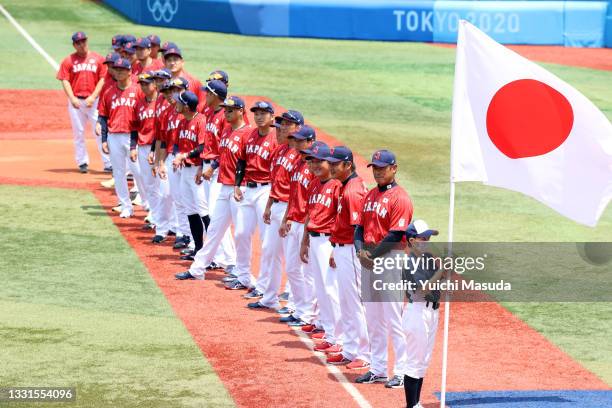 Team Japan stand on the baseline during pregame ceremonies before the game against Team Mexico during the baseball opening round Group A game on day...