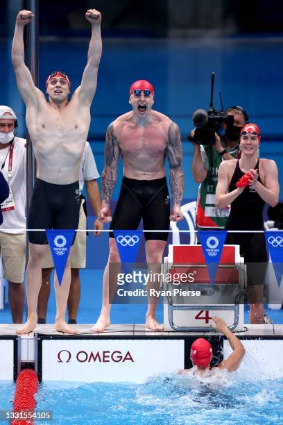 James Guy, Adam Peaty, Kathleen Dawson and Anna Hopkin of Team Great Britain react during the Mixed 4 x 100m Medley Relay Final at Tokyo Aquatics...