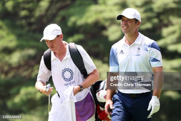 Paul Casey of Team Great Britain and caddie John McLaren walk the fifth hole during the third round of the Men's Individual Stroke Play on day eight...