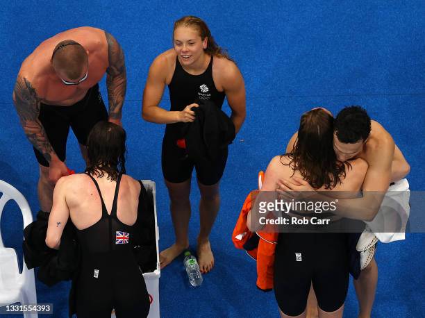 Adam Peaty, Anna Hopkins, James Guy and Kathleen Dawson of Team Great Britain react after winning the gold medal during the Mixed 4 x 100m Medley...