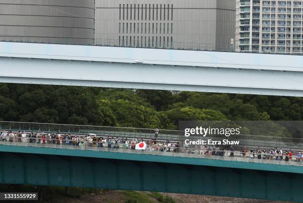 Fans watch the event from a near by bridge during the Men's BMX Freestyle seeding event, run 2 on day eight of the Tokyo 2020 Olympic Games at Ariake...