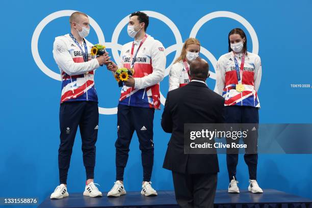 Gold medalists Adam Peaty, James Guy, Anna Hopkin and Kathleen Dawson of Team Great Britain during the medal ceremony for the Mixed 4 x 100m Medley...