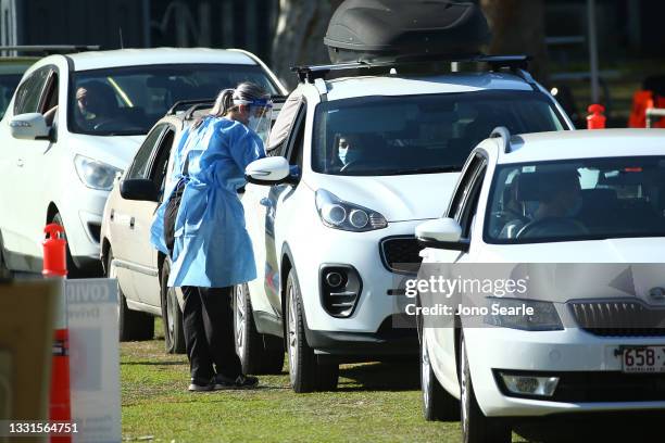 Residents are tested for COVID-19 at a pop up testing clinic at Indooroopilly State High School, on July 31, 2021 in Brisbane, Australia. Eleven...