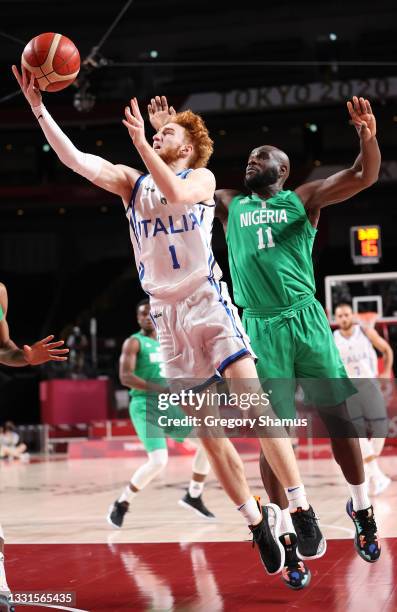 Niccolo Mannion of Team Italy drives to the basket against Obi Emegano of Team Nigeria during the first half of a Men's Basketball Preliminary Round...