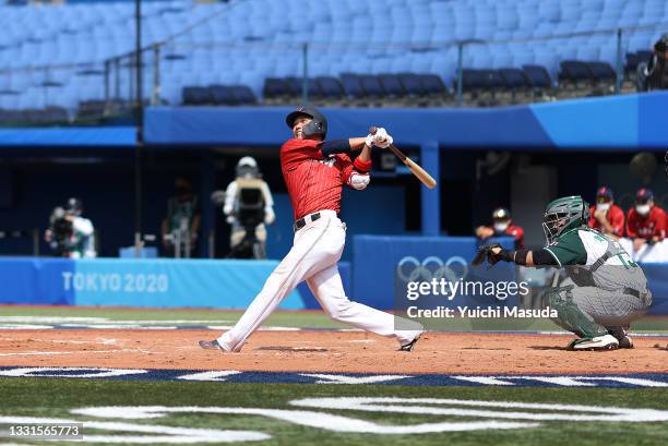 Hayato Sakamoto of Team Japan hits a solo home to left field in the seventh inning against Team Mexico during the baseball opening round Group A game...