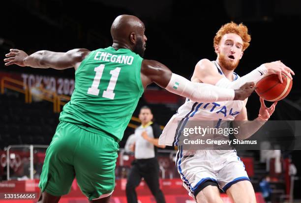 Niccolo Mannion of Team Italy is pressured by Obi Emegano of Team Nigeria during the first half of a Men's Basketball Preliminary Round Group B game...