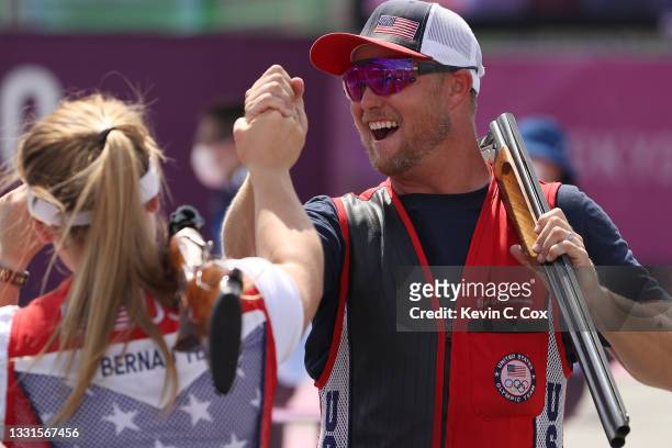 Bronze Medalists Madelynn Ann Bernau and Brian Burrows of Team United States celebrate following the Trap Mixed Team Bronze Medal Match on day eight...