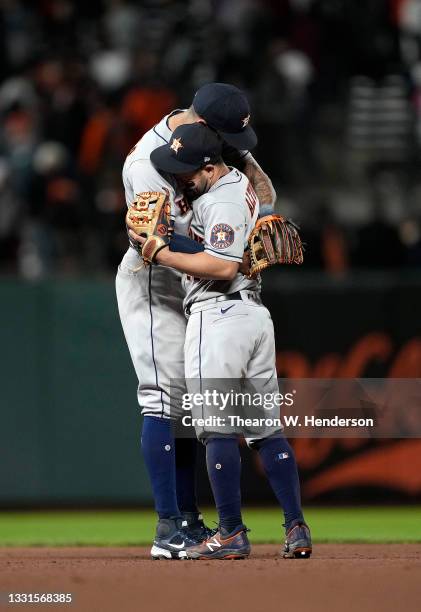 Carlos Correa and Jose Altuve of the Houston Astros hug to celebrate defeating the San Francisco Giants 9-6 at Oracle Park on July 30, 2021 in San...