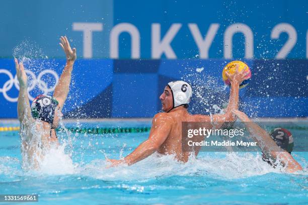 Luca Cupido of Team United States is challenged by Denes Varga and Daniel Angyal of Team Hungary during the Men's Preliminary Round Group A match...