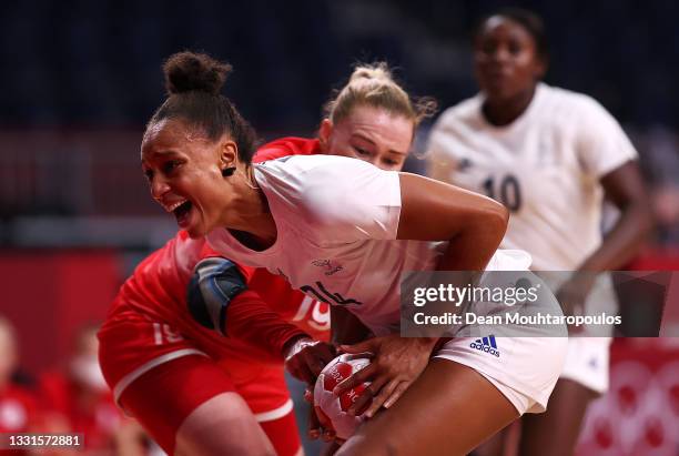 Beatrice Edwige of Team France is under pressure from Kseniia Makeeva of Team ROC during the Women's Preliminary Round Group B handball match between...