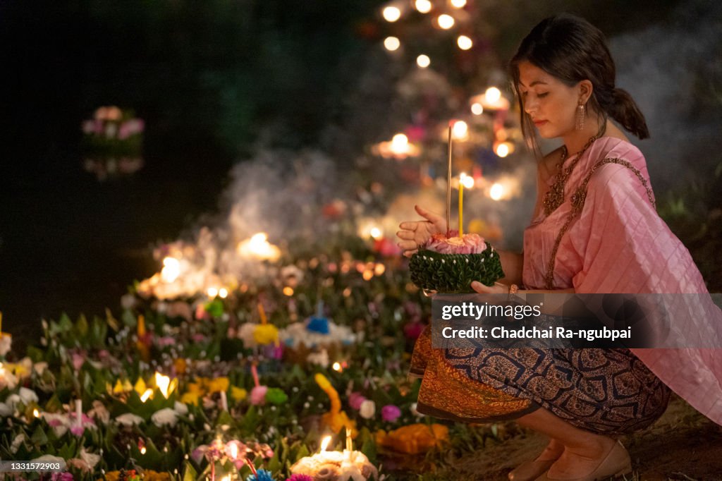 Loy Krathong Traditional Festival, Thai woman hold kratong, Thailand, Asia woman in Thai dress traditional hold kratong and bring Krathong to float in Loi kratong day of Thailand.