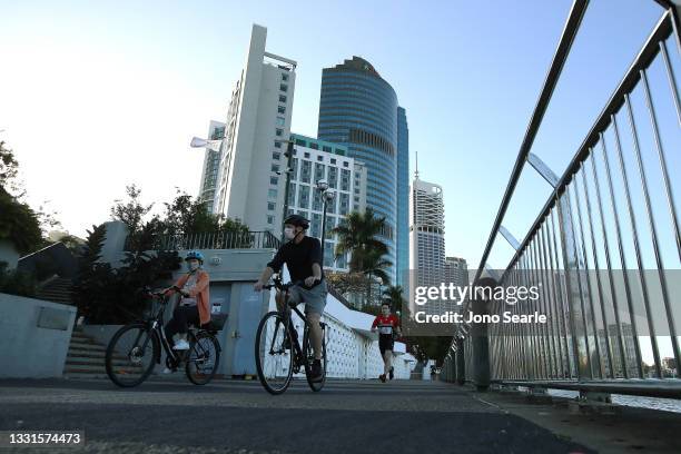 People are seen walking near the Brisbane CBD after lockdown on July 31, 2021 in Brisbane, Australia. Eleven local government areas in south-east...