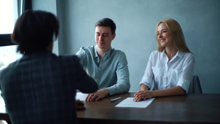 https://media.gettyimages.com/id/1331576155/video/back-view-of-happy-young-couple-sign-mortgage-contract-put-signature-on-sale-purchase-rental.jpg?b=1&s=640x640&k=20&c=A7YcXN2RRy-rGtl0mBOl6SyM2k5AA51pesGa1t3W1Pg=