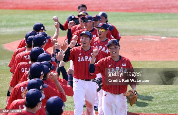 Team Japan celebrate after their 7-4 win against Team Mexico during the baseball opening round Group A game on day eight of the Tokyo 2020 Olympic...