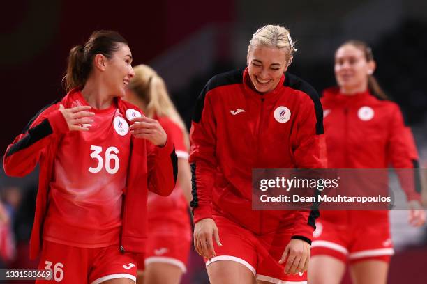 Iuliia Managarova and Anna Sen of Team ROC are seen smiling and laughing as they leave the field of play after winning the Women's Preliminary Round...