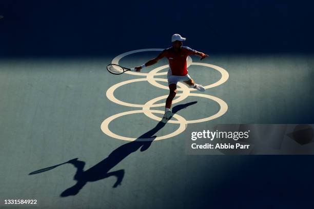 Novak Djokovic of Team Serbia hits a forehand against Pablo Carreno Busta of Team Spain during the Men's Singles Bronze Medal Match on day eight of...