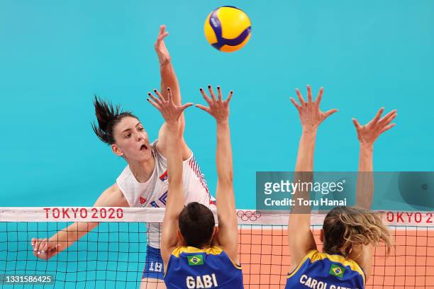 Tijana Boskovic of Team Serbia strikes against Gabriela Braga Guimaraes of Team Brazil and Caroline de Oliveira Saad Gattaz during the Women's...