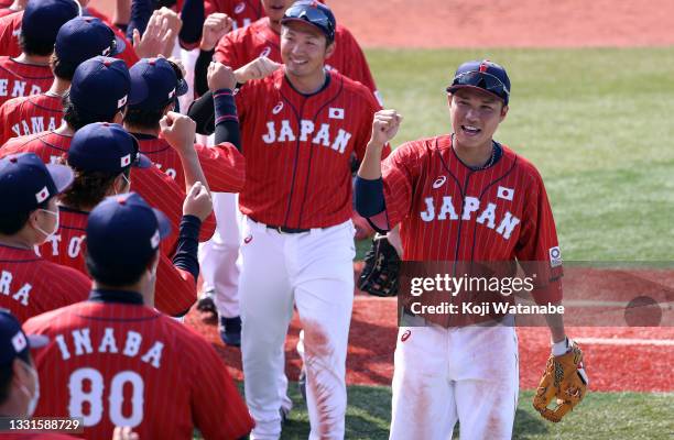 Hayato Sakamoto of Team Japan and his Team Japan teammates celebrate after their 7-4 win against Team Mexico during the baseball opening round Group...
