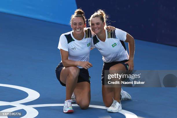 Luisa Stefani of Team Brazil and Laura Pigossi of Team Brazil celebrate victory after their Women's Doubles Bronze Medal match against Veronika...