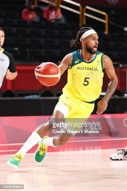 Patty Mills of Team Australia drives to the basket against Germany during the first half of a Men's Basketball Preliminary Round Group B game on day...