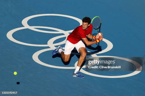 Pablo Carreno Busta of Team Spain plays a backhand during his Men's Singles Bronze Medal match against Novak Djokovic of Team Serbia on day eight of...