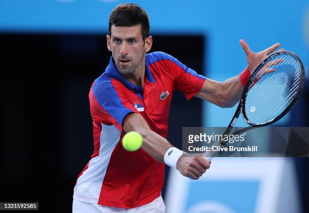 Novak Djokovic of Team Serbia plays a backhand during his Men's Singles Bronze Medal match against Pablo Carreno Busta of Team Spain on day eight of...
