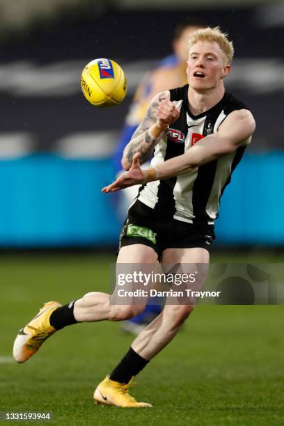 John Noble of the Magpies handballs during the round 20 AFL match between Collingwood Magpies and West Coast Eagles at Melbourne Cricket Ground on...