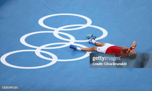 Pablo Carreno Busta of Team Spain celebrates victory after his Men's Singles Bronze Medal match against Novak Djokovic of Team Serbia on day eight of...