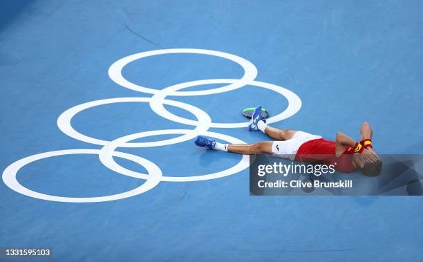 Pablo Carreno Busta of Team Spain celebrates victory after his Men's Singles Bronze Medal match against Novak Djokovic of Team Serbia on day eight of...