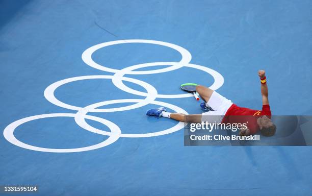 Pablo Carreno Busta of Team Spain celebrates victory after his Men's Singles Bronze Medal match against Novak Djokovic of Team Serbia on day eight of...