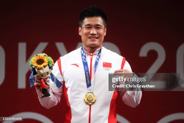 Gold medalist Xiaojun Lyu of Team China poses with the gold medal during the medal ceremony for the Weightlifting - Men's 81kg Group A on day eight...