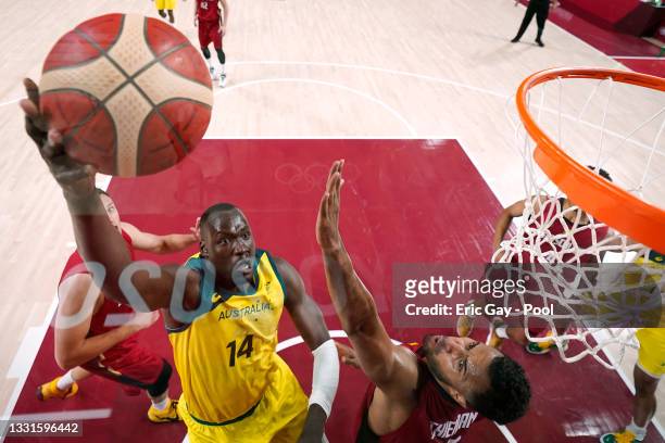 Duop Reath of Team Australia drives to the basket against Johannes Thiemann of Team Germany during the first half of a Men's Basketball Preliminary...