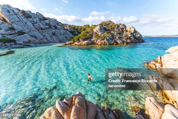woman swimming at cala napoletana, beautiful bay in caprera, la maddalena archipelago, sardinia, italy - island of caprera photos et images de collection