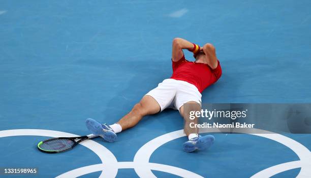 Pablo Carreno Busta of Team Spain celebrates victory after his Men's Singles Bronze Medal match against Novak Djokovic of Team Serbia on day eight of...