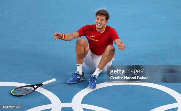 Pablo Carreno Busta of Team Spain celebrates victory after his Men's Singles Bronze Medal match against Novak Djokovic of Team Serbia on day eight of...