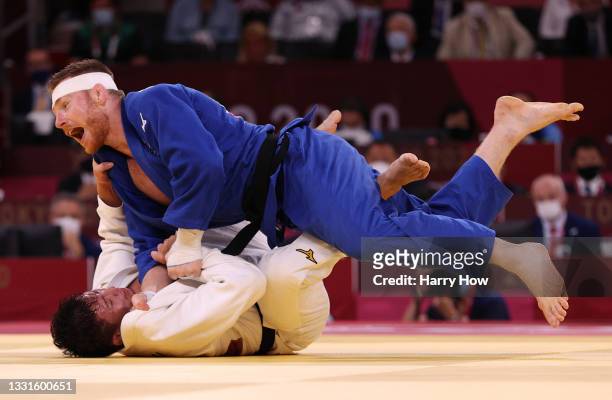 Axel Clerget of Team France defeats Shoichiro Mukai during the Mixed Team Final on day eight of the Tokyo 2020 Olympic Games at Nippon Budokan on...