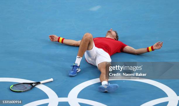 Pablo Carreno Busta of Team Spain celebrates victory after his Men's Singles Bronze Medal match against Novak Djokovic of Team Serbia on day eight of...