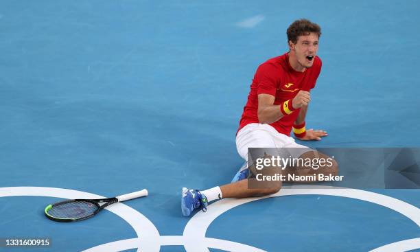 Pablo Carreno Busta of Team Spain celebrates victory after his Men's Singles Bronze Medal match against Novak Djokovic of Team Serbia on day eight of...