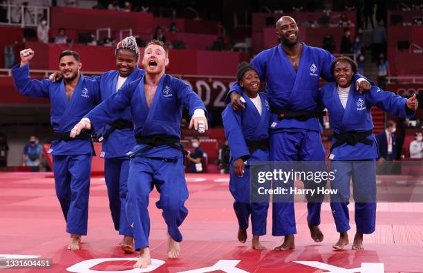 Team France celebrate victory over Team Japan during the Mixed Team Final to claim the gold medal on day eight of the Tokyo 2020 Olympic Games at...