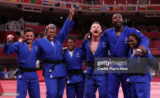 Team France celebrate victory over Team Japan during the Mixed Team Final to claim the gold medal on day eight of the Tokyo 2020 Olympic Games at...