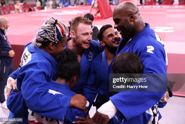 Team France celebrate victory over Team Japan during the Mixed Team Final to claim the gold medal on day eight of the Tokyo 2020 Olympic Games at...