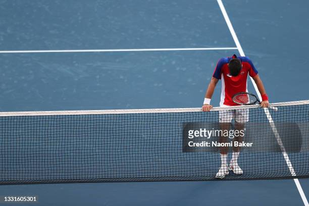 Novak Djokovic of Team Serbia waits at the net to congratulate Pablo Carreno Busta of Team Spain on his victory after their Men's Singles Bronze...