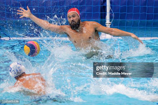 Vincenzo Dolce of Team Italy scores a penalty shot past Katsuyuki Tanamura of Team Japan during the Men's Preliminary Round Group A match between...