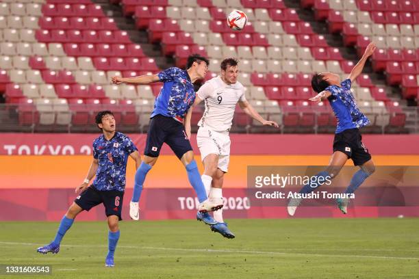 Chris Wood of Team New Zealand competes for a header with Takehiro Tomiyasu of Team Japan during the Men's Quarter Final match between Japan and New...