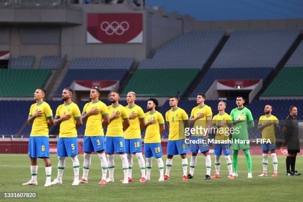 Players of Team Brazil stand for the national anthem prior to the Men's Quarter Final between Brazil and Egypt on day eight of the Tokyo Olympic...